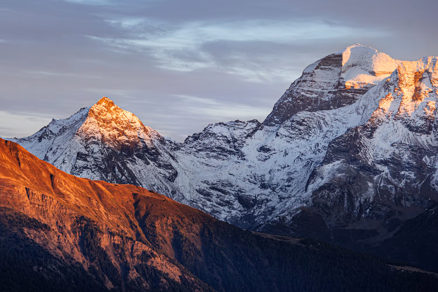 Rote Berggipfel im Sonnenuntergang mit etwas Schnee